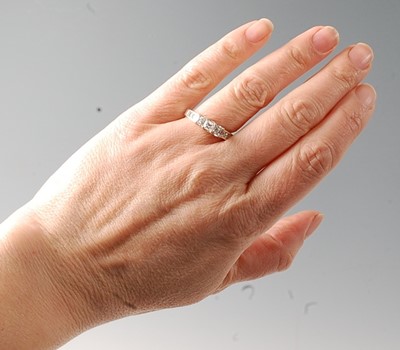 Lot 2783 - A white metal diamond three stone ring...