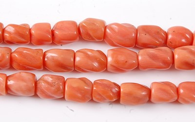 Lot 2814 - A carved coral three-string necklace, having...