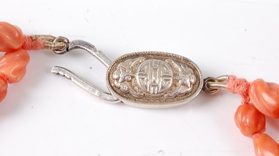 Lot 2814 - A carved coral three-string necklace, having...