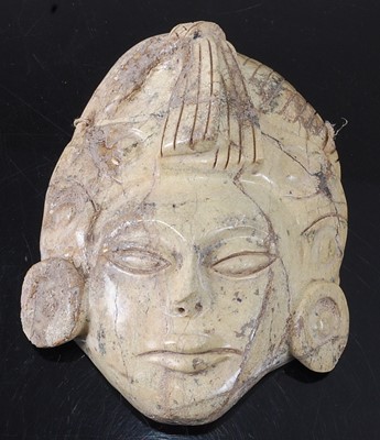 Lot 340 - * A carved stone face mask, h.15cm, together...