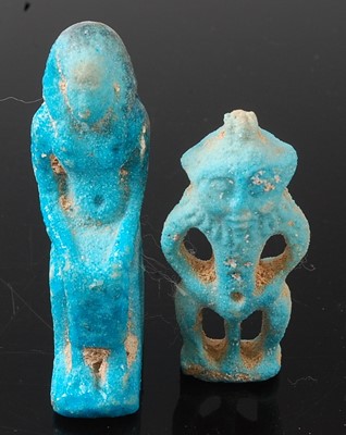 Lot 368 - * A turquoise faience deity amulet, the seated...