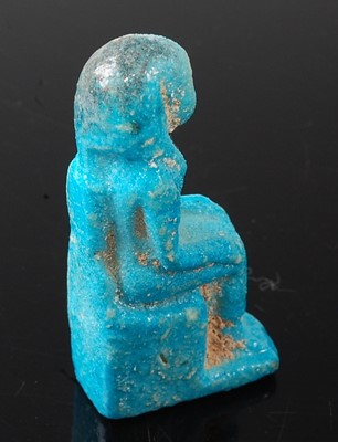 Lot 368 - * A turquoise faience deity amulet, the seated...