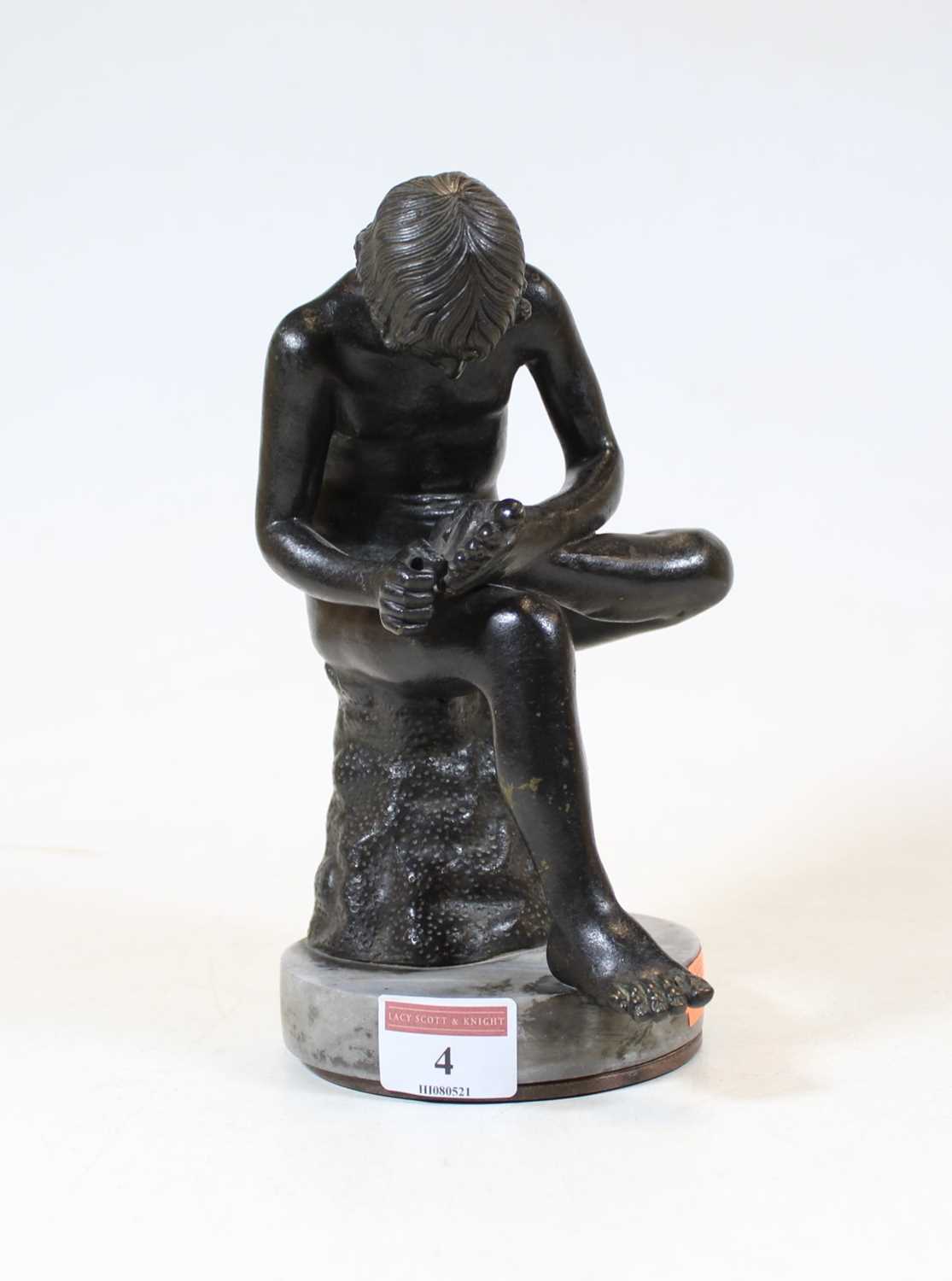 Lot 4 - A bronze figure of a boy, shown in seated pose...