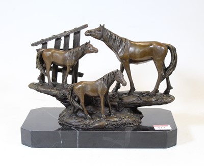 Lot 127 - A bronzed figure group of three horses, on a...