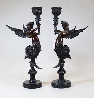 Lot 148 - A pair of bronze candlesticks, each in the...