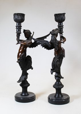 Lot 148 - A pair of bronze candlesticks, each in the...