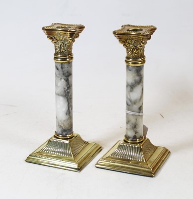 Lot 220 - A pair of brass and marble table candlesticks...