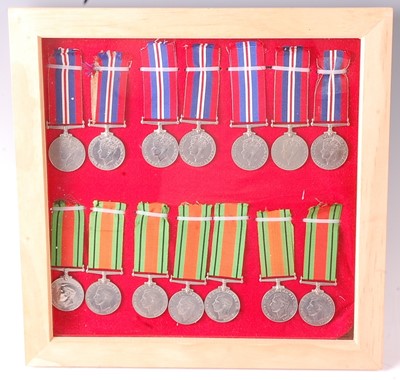 Lot 2108 - A framed collection of fourteen WW II medals...
