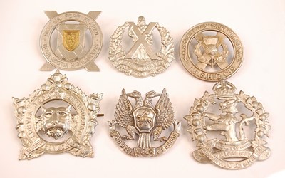 Lot 2398 - A collection of cap and glengarry badges to...