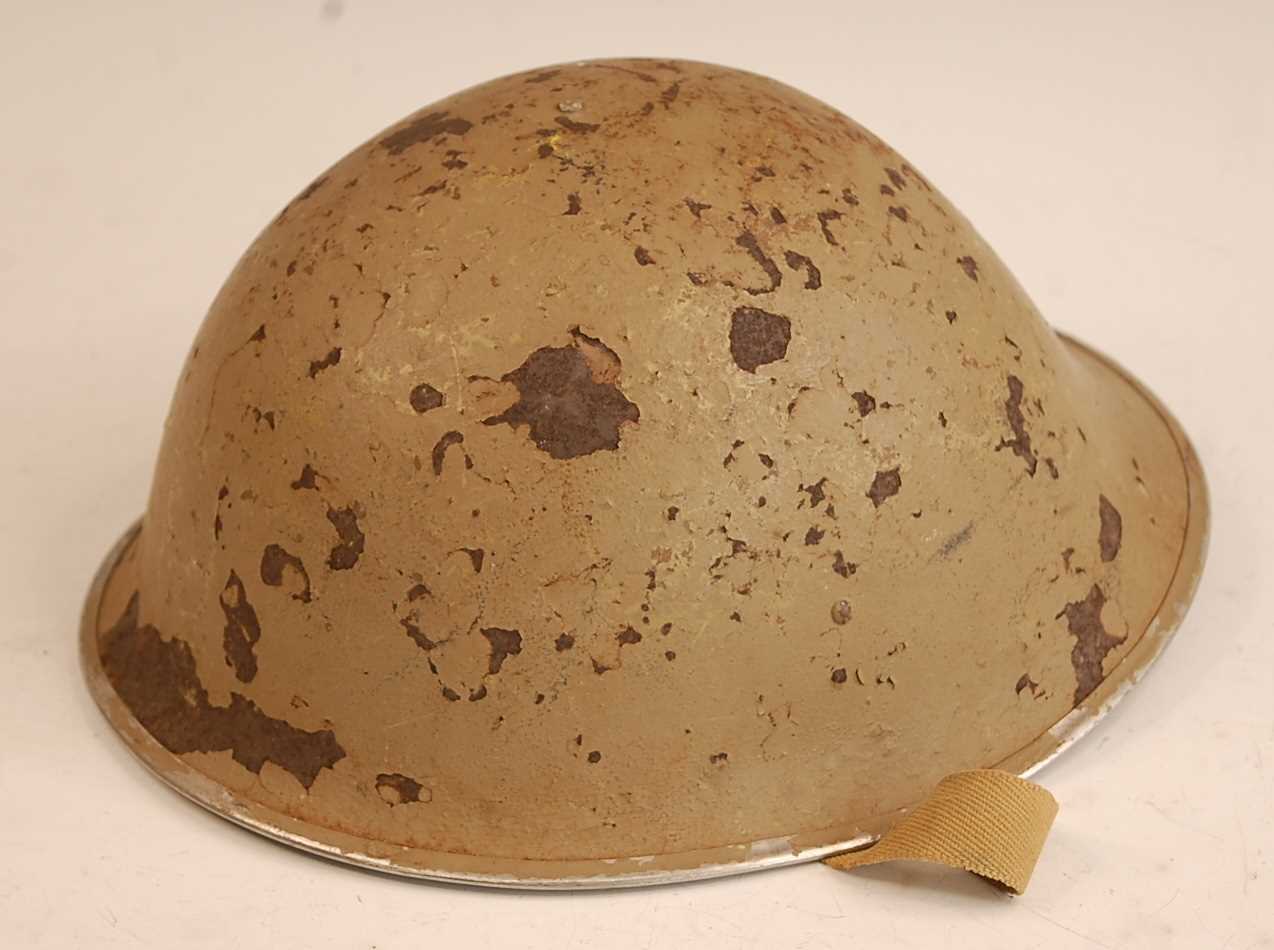 Lot 100 - A British Mk III steel helmet with leather...
