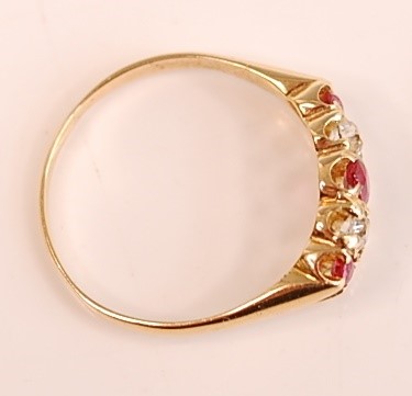 Lot 3098 - A yellow metal, ruby and diamond half hoop...