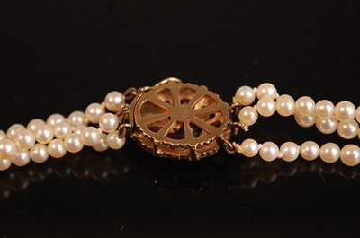 Lot 3095 - A three-row cultured pearl necklet, comprising...