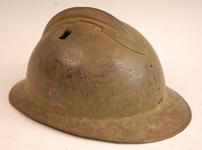 Lot 2428 - A French M26 steel helmet with combat damage...