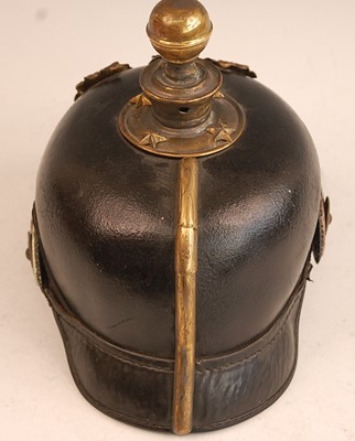 Lot 104 - A Prussian pickelhaube, the leather skull with...