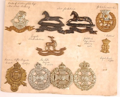 Lot 2210 - A collection of cap and collar badges to...