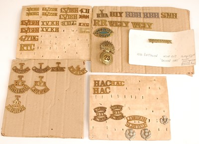 Lot 2219 - A collection of shoulder titles, collar badges...