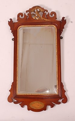 Lot 3382 - A Victorian walnut fret carved wall mirror, in...