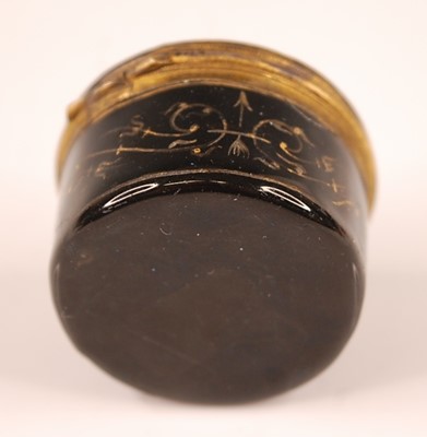 Lot 3173 - A gilt and enamel decorated circular pill box,...