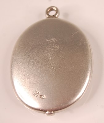Lot 3105 - A heavy white metal oval locket, having three...