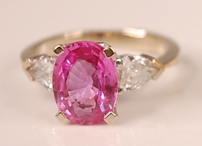 Lot 3108 - A white metal, pink sapphire and diamond three...