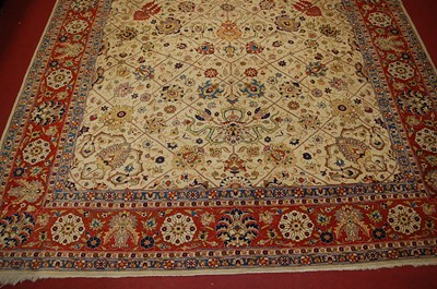 Lot 3334 - A Persian woollen cream ground carpet,...