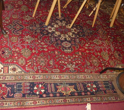 Lot 3336 - A Persian woollen Kashan carpet, having a red...