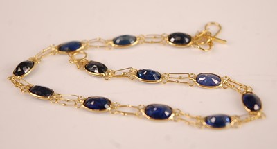 Lot 3090 - A contemporary yellow metal and sapphire set...