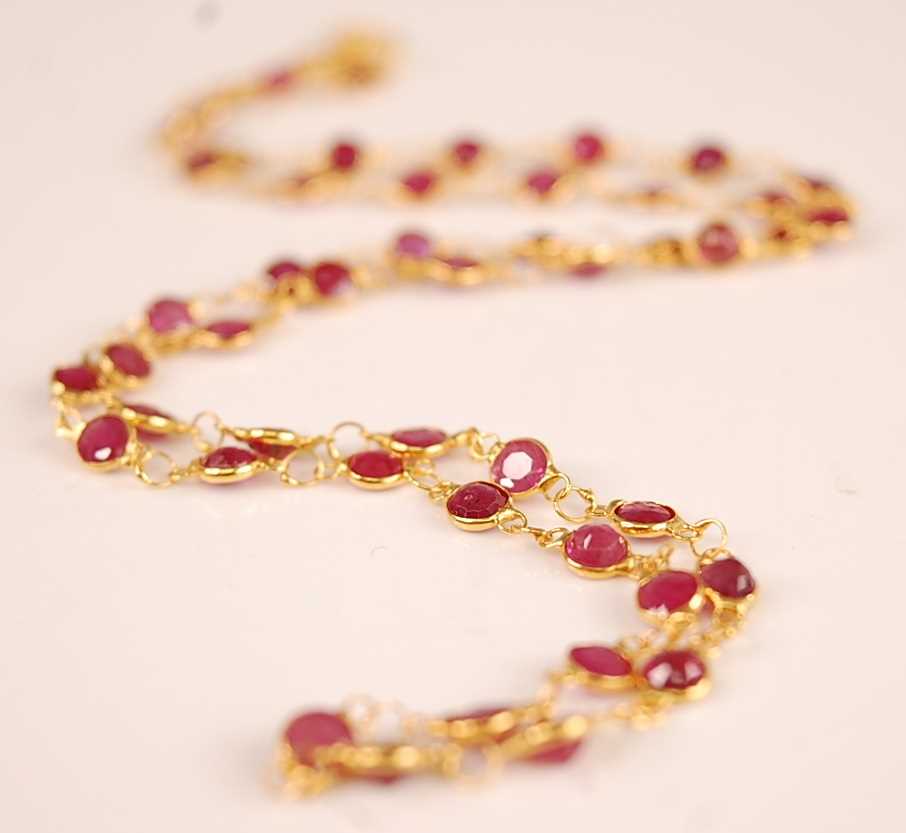 Lot 3131 - A contemporary yellow metal and ruby necklace,...