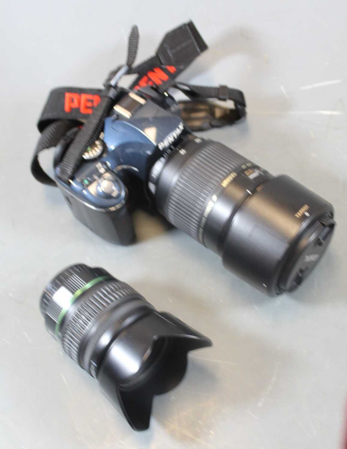 Lot 607 - A Pentax K-X digital SLR camera, together with...