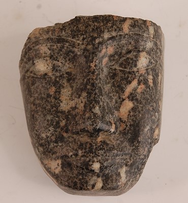 Lot 369 - * A granite fragment, carved as a face,...