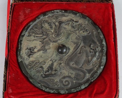 Lot 256 - * A Chinese cast bronze mirror, of circular...