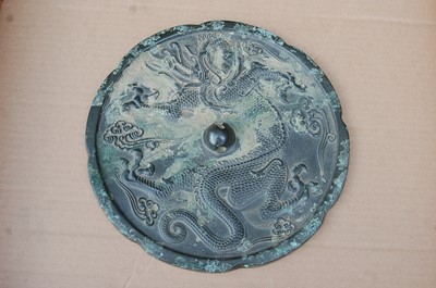Lot 256 - * A Chinese cast bronze mirror, of circular...