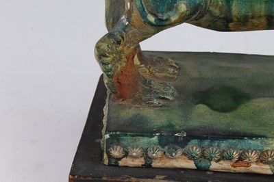 Lot 270 - A Chinese green glazed pottery figure of a Fu...