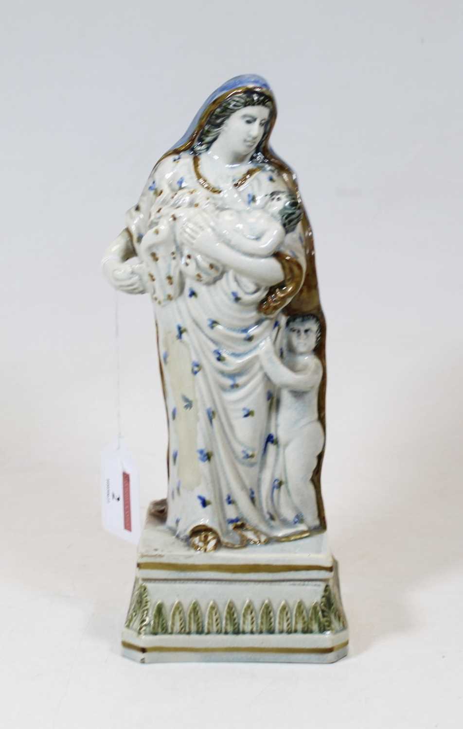 Lot 2 - A pearlware figure group of Charity, shown...