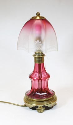 Lot 9 - A 20th century rose glass and brass table lamp,...