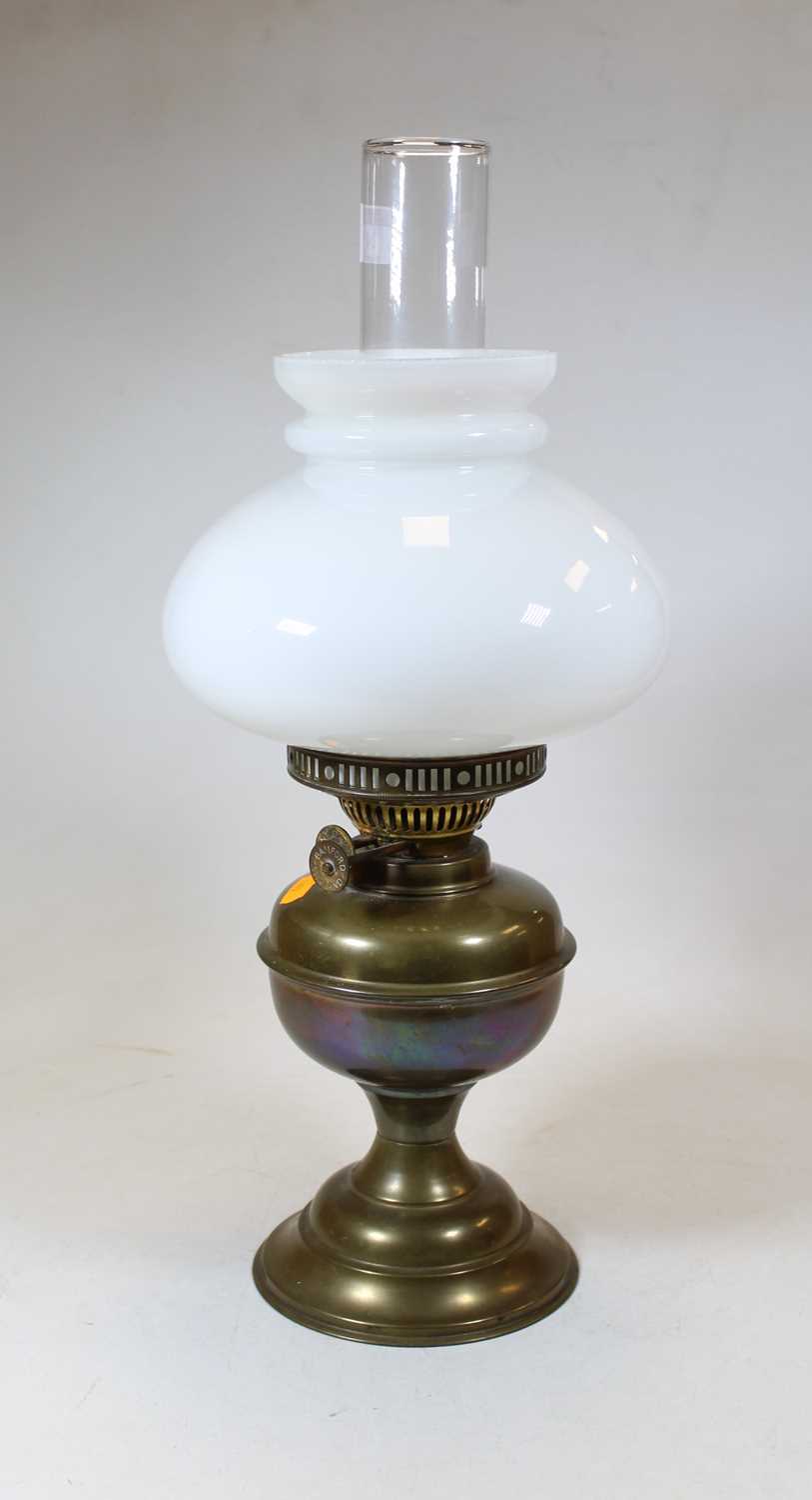 Lot 24 - A 19th century brass oil lamp, with milk glass...