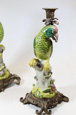 Lot 70 - A pair of gilt metal mounted porcelain parrot...