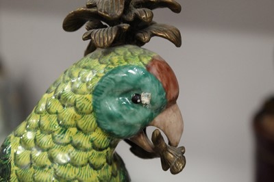Lot 70 - A pair of gilt metal mounted porcelain parrot...