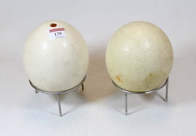 Lot 129 - An ostrich egg on stand; together with one...