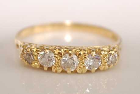 Lot 2506 - An 18ct yellow gold diamond five stone half...