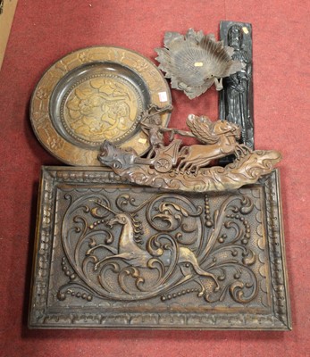 Lot 200 - A softwood panel carved with a unicorn amidst...