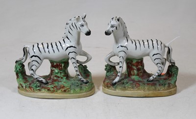 Lot 219 - A pair of Staffordshire figures of zebras,...
