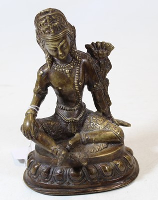 Lot 274 - An Eastern bronze deity modelled in seated...