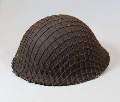 Lot 52 - A Brody pattern steel helmet with leather...