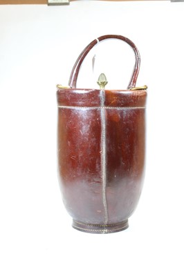 Lot 68 - A leather clad champagne/ice bucket with swing...