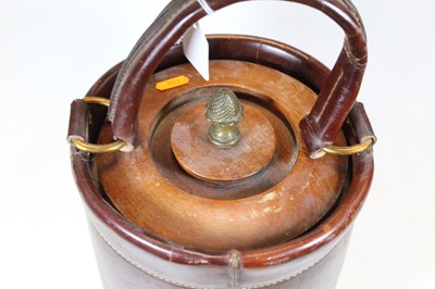 Lot 68 - A leather clad champagne/ice bucket with swing...