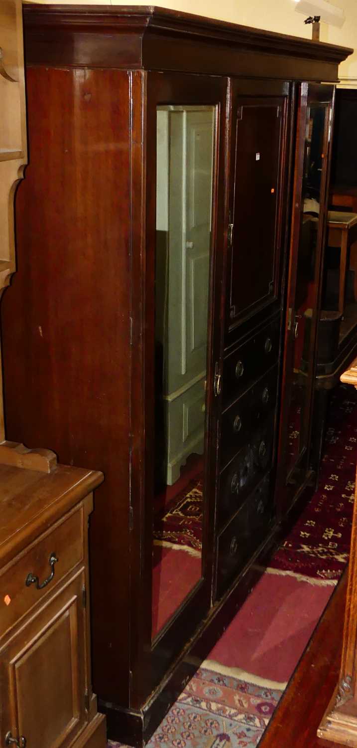 Lot 1522 - An Edwardian mahogany triple wardrobe, the...