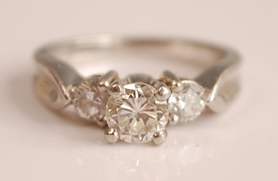 Lot 1096 - A white metal diamond three-stone ring,...