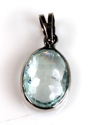 Lot 2511 - A white metal oval aquamarine pendant, the...