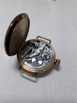 Lot 1167 - A 9ct yellow gold manual wind trench watch,...